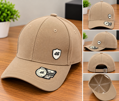 A tan baseball cap shown in a collage with multiple angles, including front, side, back, and interior views. The cap has a small shield-shaped '46' patch on the front and a sticker on the brim, photographed on a wooden surface with small plant props in the background.