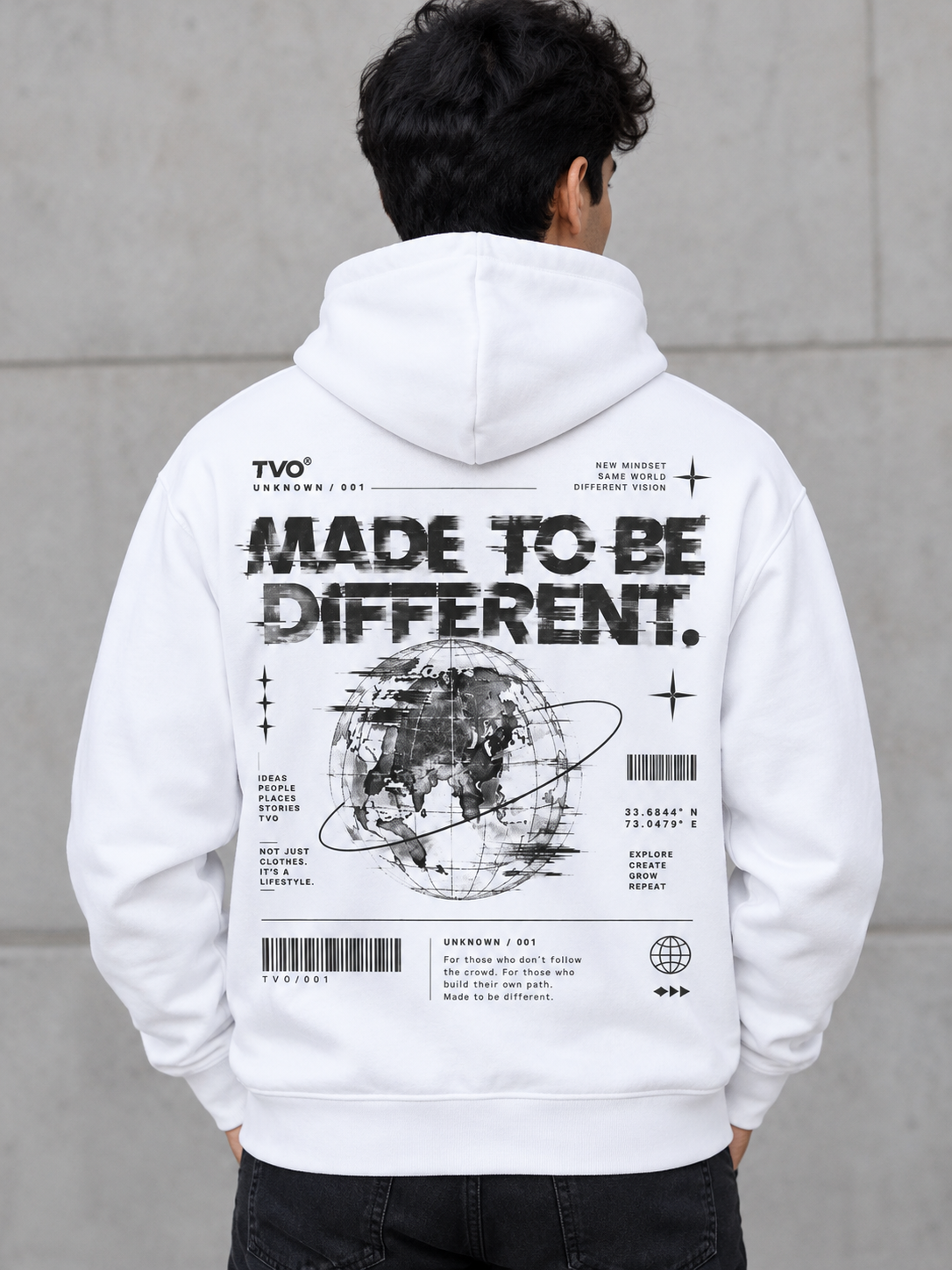 A man viewed from behind wearing a white pullover hoodie with a large black graphic print on the back. The print features the text 'MADE TO BE DIFFERENT.