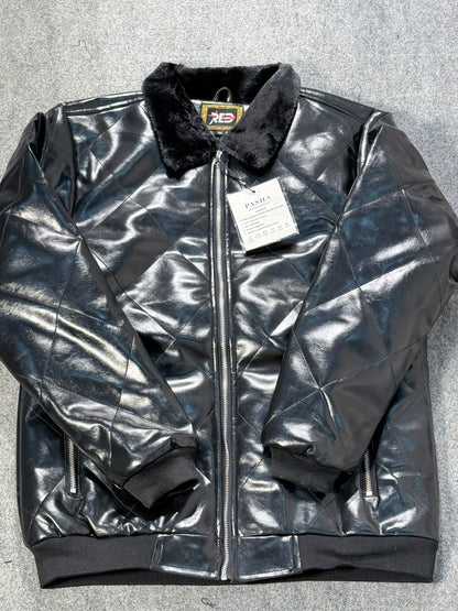 A black quilted faux-leather bomber jacket with a black faux-fur collar, shown flat on a gray textured background with a white retail tag attached.